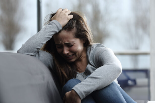 Sad girl complaining and crying at home